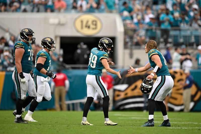 Jacksonville Jaguars place kicker Cam Little (39) reacts with Trevor Lawrence (16) after kicking a field goal during the second half of an NFL football against the Indianapolis Colts, Sunday, Oct. 6, 2024, in Jacksonville, Fla. (AP Photo/Phelan M. Ebenhack)