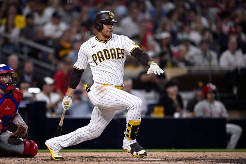 Sep 5, 2023; San Diego, California, USA; San Diego Padres left fielder Juan Soto (22) hits a single against the Philadelphia Phillies during the sixth inning at Petco Park. Mandatory Credit: Orlando Ramirez-USA TODAY Sports