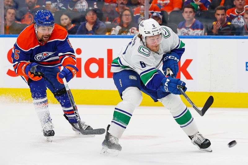 May 14, 2024; Edmonton, Alberta, CAN; Vancouver Canucks forward Brock Boeser (6) gets a shot away in front of Edmonton Oilers defensemen Cody Ceci (5) during the second period in game four of the second round of the 2024 Stanley Cup Playoffs at Rogers Place. Mandatory Credit: Perry Nelson-USA TODAY Sports