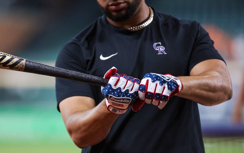 Jul 4, 2023; Houston, Texas, USA; A close up view of the red white and blue batting gloves of Colorado Rockies catcher Elias Diaz (35) before the game against the Houston Astros at Minute Maid Park. Mandatory Credit: Troy Taormina-USA TODAY Sports