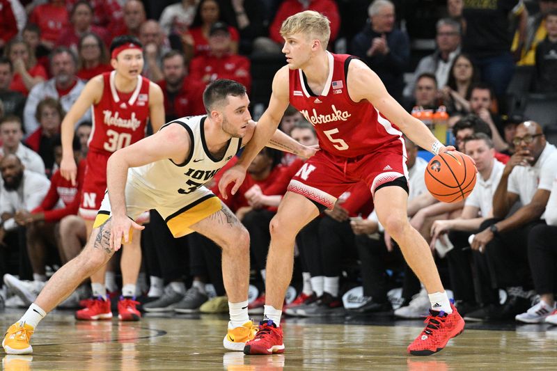 Mar 5, 2023; Iowa City, Iowa, USA; Nebraska Cornhuskers guard Sam Griesel (5) controls the ball as Iowa Hawkeyes guard Connor McCaffery (30) defends during the second half at Carver-Hawkeye Arena. Mandatory Credit: Jeffrey Becker-USA TODAY Sports