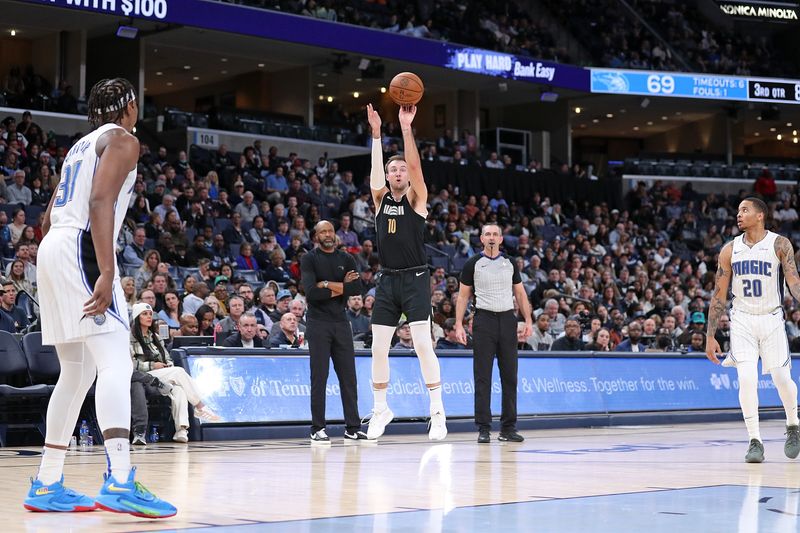 MEMPHIS, TENNESSEE - JANUARY 26: Luke Kennard #10 of the Memphis Grizzlies takes a shot during the second half against the Orlando Magic at FedExForum on January 26, 2024 in Memphis, Tennessee. NOTE TO USER: User expressly acknowledges and agrees that, by downloading and or using this photograph, User is consenting to the terms and conditions of the Getty Images License Agreement. (Photo by Justin Ford/Getty Images)