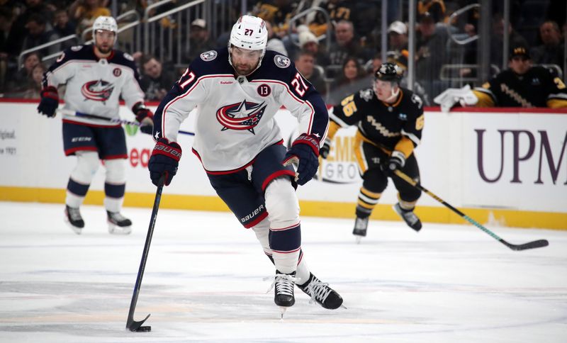 Jan 7, 2025; Pittsburgh, Pennsylvania, USA; Columbus Blue Jackets center Zachary Aston-Reese (27) breaks up ice with the puck against the Pittsburgh Penguins during the second period at PPG Paints Arena. Mandatory Credit: Charles LeClaire-Imagn Images