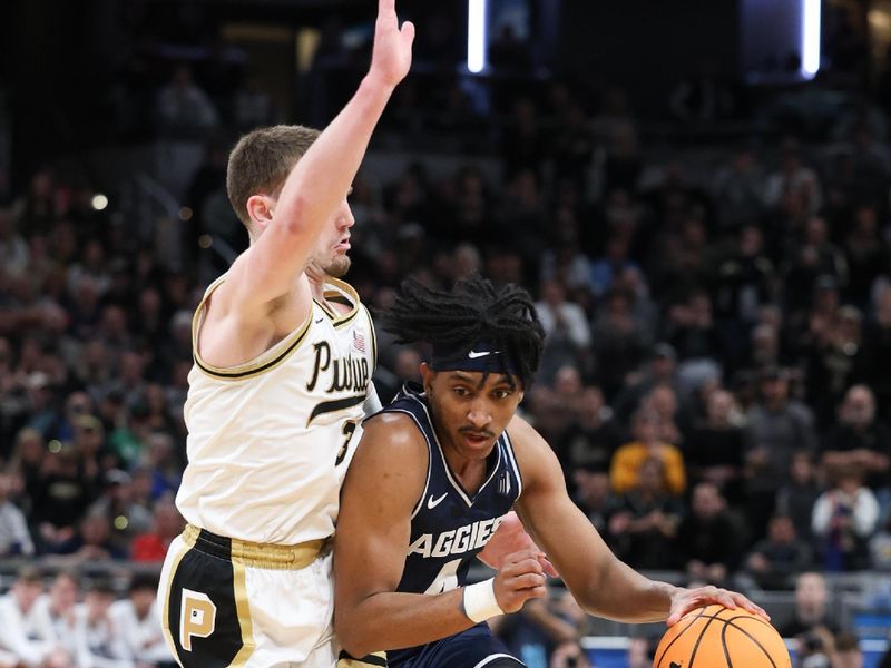 Mar 24, 2024; Indianapolis, IN, USA; Utah State Aggies guard Ian Martinez (4) dribbles against Purdue Boilermakers guard Braden Smith (3) during the first half at Gainbridge FieldHouse. Mandatory Credit: Trevor Ruszkowski-USA TODAY Sports