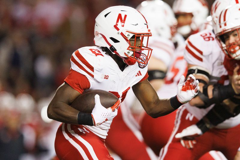 Nov 18, 2023; Madison, Wisconsin, USA;  Nebraska Cornhuskers running back Emmett Johnson (21) rushes with the football during the first quarter against the Wisconsin Badgers at Camp Randall Stadium. Mandatory Credit: Jeff Hanisch-USA TODAY Sports