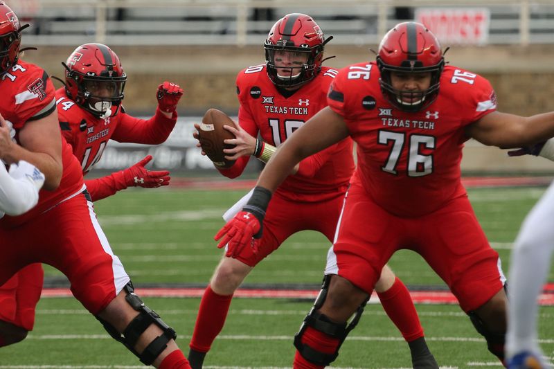 Dec 5, 2020; Lubbock, Texas, USA;  Texas Tech Red Raiders quarterback Alan Bowman (10) takes a snap from center in the first half in the game against the Kansas Jayhawks at Jones AT&T Stadium. Mandatory Credit: Michael C. Johnson-USA TODAY Sports