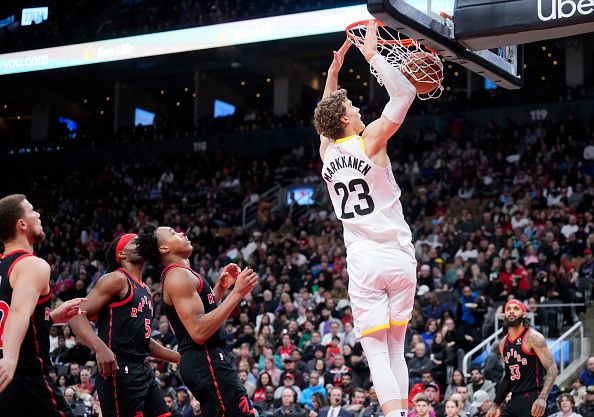 TORONTO, ON - DECEMBER 23: Lauri Markkanen #23 of the Utah Jazz dunks past Scottie Barnes #4 of the Toronto Raptors during the second half of their basketball game at the Scotiabank Arena on December 23, 2023 in Toronto, Ontario, Canada. NOTE TO USER: User expressly acknowledges and agrees that, by downloading and/or using this Photograph, user is consenting to the terms and conditions of the Getty Images License Agreement. (Photo by Mark Blinch/Getty Images)