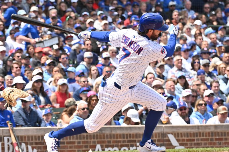 May 26, 2025; Chicago, Illinois, USA; Chicago Cubs shortstop Dansby Swanson (7) hits a sacrifice ground out RBI during the first inning against the Colorado Rockies at Wrigley Field. Mandatory Credit: Patrick Gorski-Imagn Images