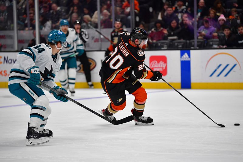 Jan 31, 2024; Anaheim, California, USA; Anaheim Ducks right wing Brett Leason (20) moves the puck ahead of San Jose Sharks left wing Alexander Barabanov (94) during the second period at Honda Center. Mandatory Credit: Gary A. Vasquez-USA TODAY Sports