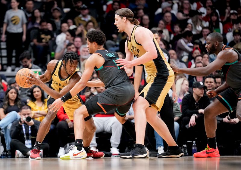 TORONTO, ON - APRIL 7: Immanuel Quickley #5 and Kelly Olynyk #41 of the Toronto Raptors is defended by Jordan Poole #13 of the Washington Wizards during the first half of their basketball game at the Scotiabank Arena on April 7, 2024 in Toronto, Ontario, Canada. NOTE TO USER: User expressly acknowledges and agrees that, by downloading and/or using this Photograph, user is consenting to the terms and conditions of the Getty Images License Agreement. (Photo by Mark Blinch/Getty Images)