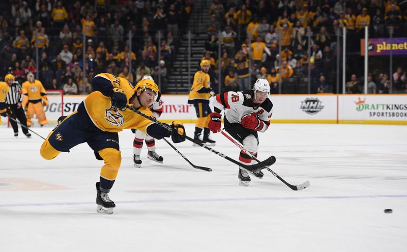 Jan 26, 2023; Nashville, Tennessee, USA; Nashville Predators left wing Tanner Jeannot (84) scores the empty net goal during the third period against the New Jersey Devils at Bridgestone Arena. Mandatory Credit: Christopher Hanewinckel-USA TODAY Sports