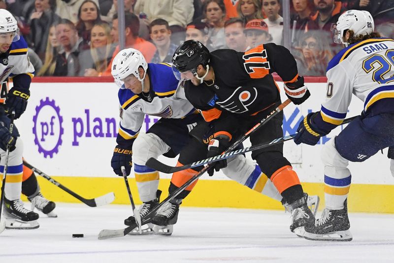 Oct 31, 2024; Philadelphia, Pennsylvania, USA; St. Louis Blues center Dylan Holloway (81) and Philadelphia Flyers right wing Tyson Foerster (71) battle for the puck during the second period at Wells Fargo Center. Mandatory Credit: Eric Hartline-Imagn Images