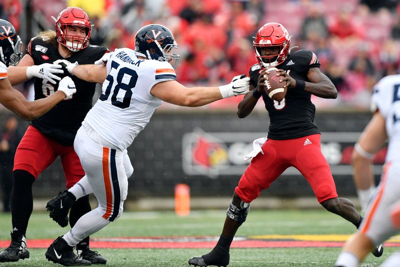 Oct 26, 2019; Louisville, KY, USA; Louisville Cardinals quarterback Micale Cunningham (3) tries to avoid a sack for Virginia Cavaliers defensive tackle Eli Hanback (58) during the first quarter of play at Cardinal Stadium. Mandatory Credit: Jamie Rhodes-USA TODAY Sports