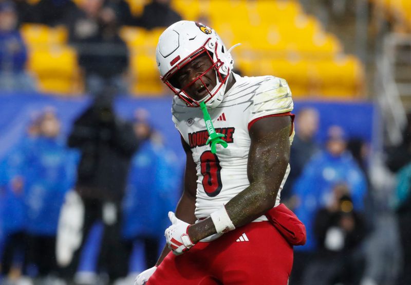 Oct 14, 2023; Pittsburgh, Pennsylvania, USA; Louisville Cardinals wide receiver Chris Bell (0) reacts after a seven yard touchdown catch against the Pittsburgh Panthers during the first quarter at Acrisure Stadium. Mandatory Credit: Charles LeClaire-USA TODAY Sports