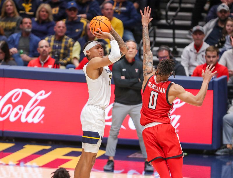 Mar 2, 2024; Morgantown, West Virginia, USA; West Virginia Mountaineers guard RaeQuan Battle (21) shoots a three pointer over Texas Tech Red Raiders guard Chance McMillian (0) during the first half at WVU Coliseum. Mandatory Credit: Ben Queen-USA TODAY Sports