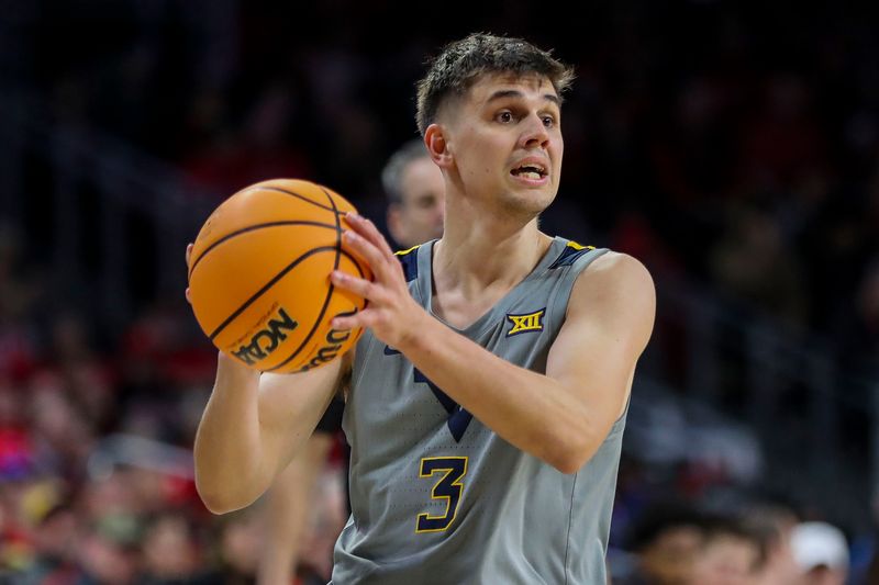 Mar 9, 2024; Cincinnati, Ohio, USA; West Virginia Mountaineers guard Kerr Kriisa (3) holds the ball against the Cincinnati Bearcats in the second half at Fifth Third Arena. Mandatory Credit: Katie Stratman-USA TODAY Sports