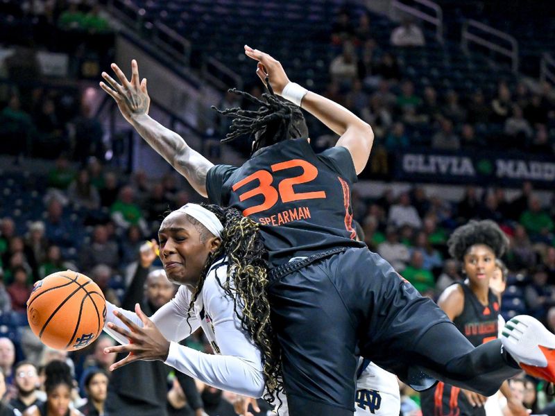 Jan 14, 2024; South Bend, Indiana, USA; Notre Dame Fighting Irish guard KK Bransford (14) is fouled by Miami Hurricanes forward Lazaria Spearman (32) in the first half at the Purcell Pavilion. Mandatory Credit: Matt Cashore-USA TODAY Sports