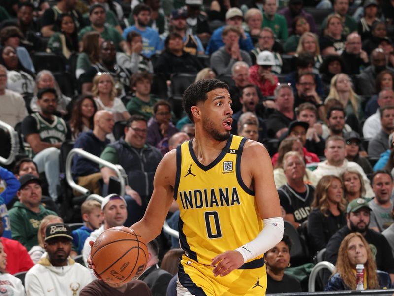 MILWAUKEE, WI - APRIL 21: Tyrese Haliburton #0 of the Indiana Pacers dribbles the ball during the game against the Milwaukee Bucks during Round 1 Game 1 of the 2024 NBA Playoffs on April 21, 2024 at the Fiserv Forum Center in Milwaukee, Wisconsin. NOTE TO USER: User expressly acknowledges and agrees that, by downloading and or using this Photograph, user is consenting to the terms and conditions of the Getty Images License Agreement. Mandatory Copyright Notice: Copyright 2024 NBAE (Photo by Gary Dineen/NBAE via Getty Images).