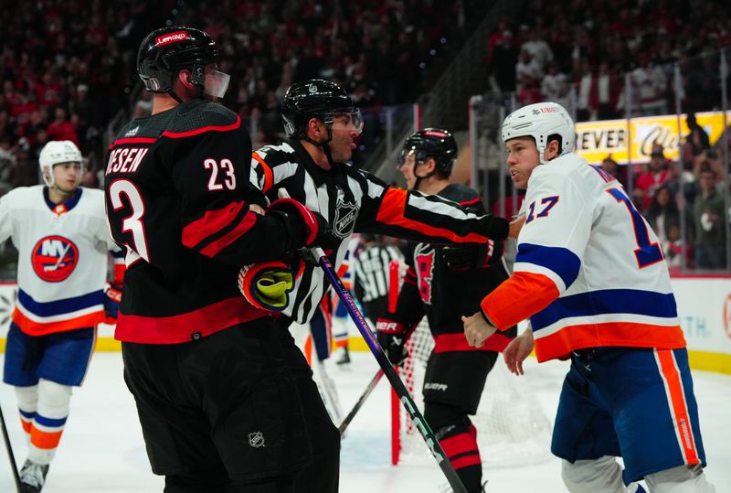 Apr 22, 2024; Raleigh, North Carolina, USA; Carolina Hurricanes right wing Stefan Noesen (23) and New York Islanders left wing Matt Martin (17) battle during the third period in game two of the first round of the 2024 Stanley Cup Playoffs at PNC Arena. Mandatory Credit: James Guillory-USA TODAY Sports