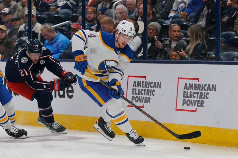 Oct 17, 2024; Columbus, Ohio, USA; Buffalo Sabres defenseman Bowen Byram (4) carries the puck away from Columbus Blue Jackets left wing James van Riemsdyk (21) during the second period at Nationwide Arena. Mandatory Credit: Russell LaBounty-Imagn Images