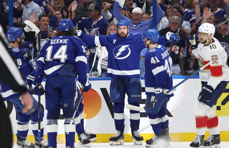Apr 30, 2025; Tampa, Florida, USA; Tampa Bay Lightning left wing Nick Paul (20) is congratulated  by teammates after he scored a goal against the Florida Panthers during the first period of game five of the first round of the 2025 Stanley Cup Playoffs at Amalie Arena. Mandatory Credit: Kim Klement Neitzel-Imagn Images