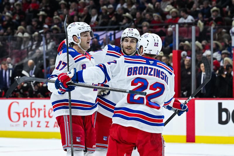 Dec 4, 2025; Ottawa, Ontario, CAN; New York Rangers defenseman Will Borgen (17) celebrates with defenseman Carson Soucy (24) and center Jonny Brodzinski (22) his goal against the Ottawa Senators during the second period at Canadian Tire Centre. Mandatory Credit: David Kirouac-Imagn Images