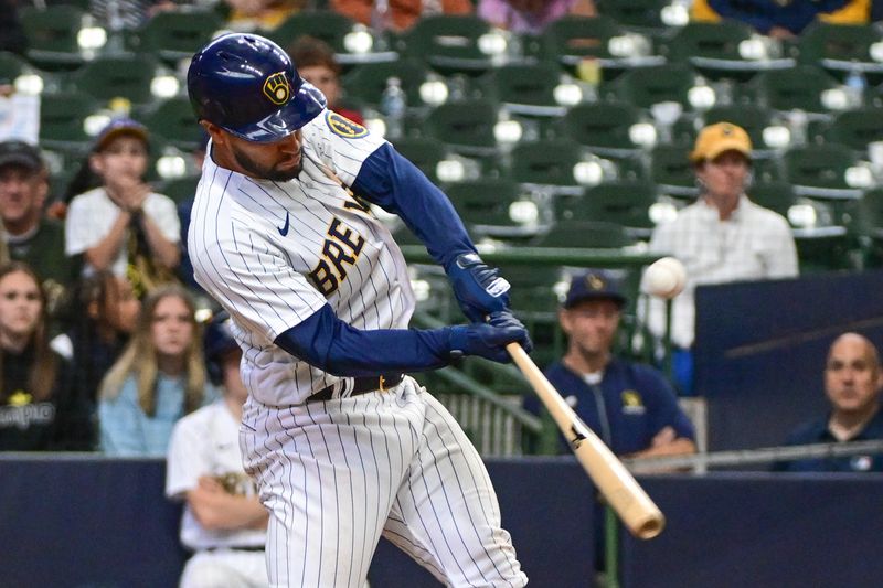 Jun 11, 2023; Milwaukee, Wisconsin, USA;  Milwaukee Brewers third baseman Abraham Toro (13) hits a single to drive in two runs against the Oakland Athletes in the ninth inning at American Family Field. Mandatory Credit: Benny Sieu-USA TODAY Sports