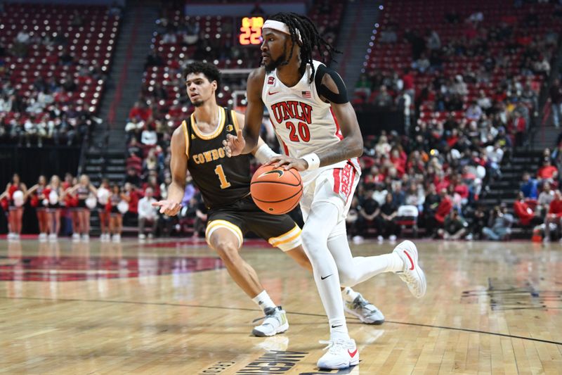 Feb 3, 2024; Las Vegas, Nevada, USA; UNLV Rebels forward Keylan Boone (20) dribbles past Wyoming Cowboys guard Brendan Wenzel (1) in the first half at Thomas & Mack Center. Mandatory Credit: Candice Ward-USA TODAY Sports