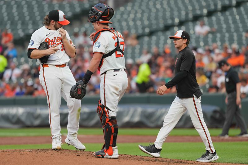 Jul 10, 2024; Baltimore, Maryland, USA; Baltimore Orioles pitcher Corbin Burnes (39) is joined by catcher James McCann (center) and pitching coach Drew French (right) during the second inning against the Chicago Cubs at Oriole Park at Camden Yards. Mandatory Credit: Mitch Stringer-USA TODAY Sports