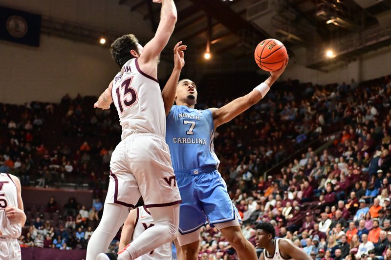 Mar 4, 2025; Blacksburg, Virginia, USA; North Carolina Tar Heels guard Seth Trimble (7) goes up for a layup as Virginia Tech Hokies forward Ben Burnham (13) defends during the second half at Cassell Coliseum. Mandatory Credit: Brian Bishop-Imagn Images