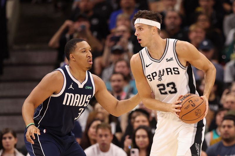 SAN ANTONIO, TEXAS - OCTOBER 25: Zach Collins #23 of the San Antonio Spurs handles the ball against Grant Williams #3 of the Dallas Mavericks during the NBA game at Frost Bank Center on October 25, 2023 in San Antonio, Texas.  The Mavericks defeated the Spurs 126-119. NOTE TO USER: User expressly acknowledges and agrees that, by downloading and or using this photograph, User is consenting to the terms and conditions of the Getty Images License Agreement.  (Photo by Christian Petersen/Getty Images)