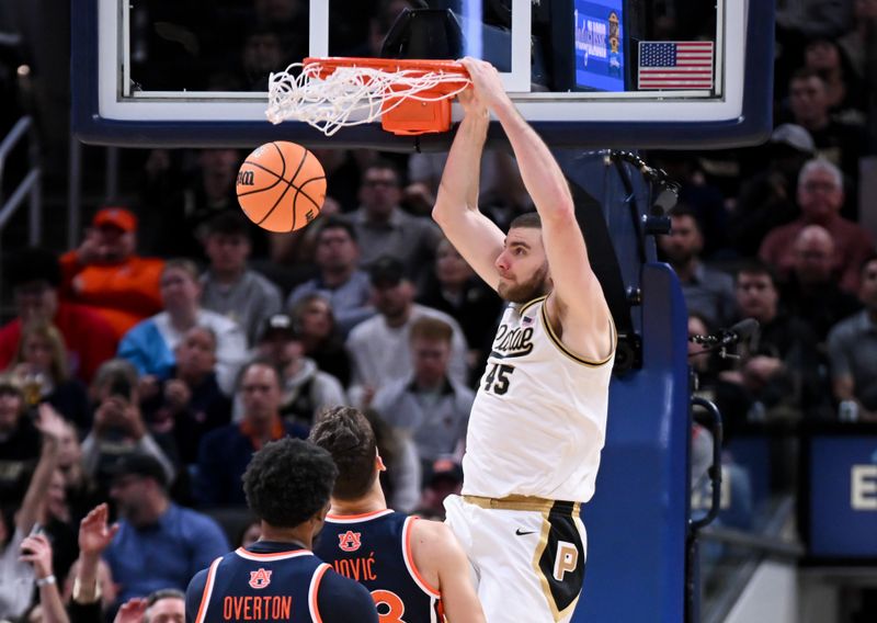 Dec 20, 2025; Indianapolis, Indiana, USA; Purdue Boilermakers center Oscar Cluff (45) dunks the ball past Auburn Tigers forward Filip Jovic (38) during the first half at Gainbridge Fieldhouse. Mandatory Credit: Robert Goddin-Imagn Images