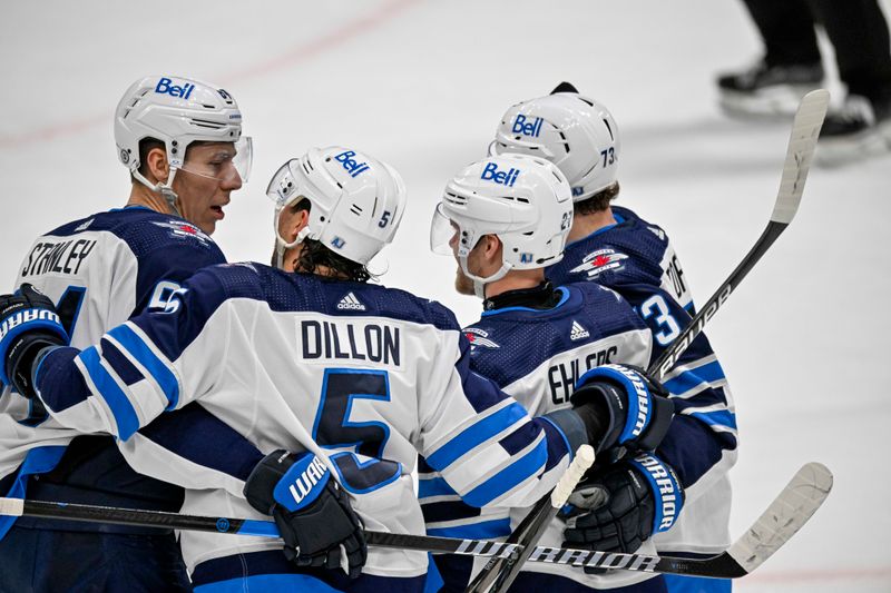 Apr 11, 2024; Dallas, Texas, USA; Winnipeg Jets defenseman Logan Stanley (64) and defenseman Brenden Dillon (5) and left wing Nikolaj Ehlers (27) and right wing Tyler Toffoli (73) celebrates a goal scored by Ehlers against the Dallas Stars and during the first period at the American Airlines Center. Mandatory Credit: Jerome Miron-USA TODAY Sports