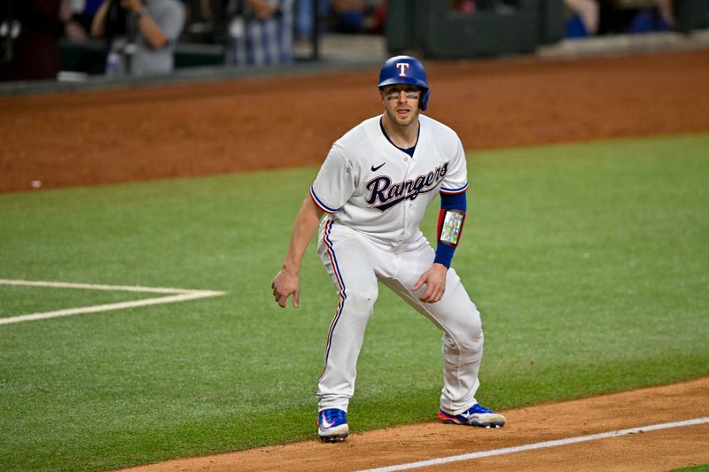 Aug 3, 2023; Arlington, Texas, USA; Texas Rangers catcher Mitch Garver (18) looks for the ball as he leads off from third base during the eighth inning against the Chicago White Sox at Globe Life Field. Mandatory Credit: Jerome Miron-USA TODAY Sports