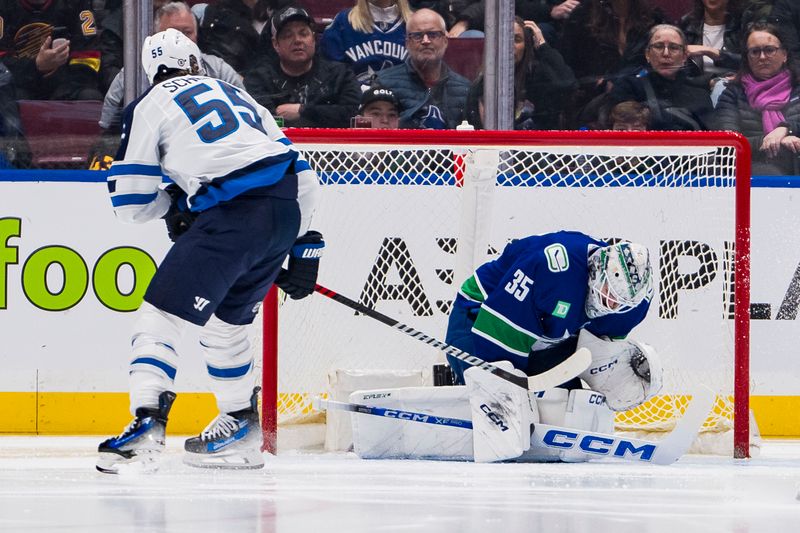 Mar 9, 2024; Vancouver, British Columbia, CAN; Vancouver Canucks goalie Thatcher Demko (35) makes a save on Winnipeg Jets forward Mark Scheifele (55) in the second period at Rogers Arena. Mandatory Credit: Bob Frid-USA TODAY Sports