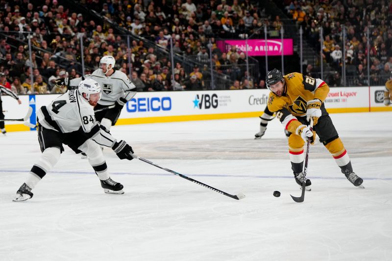 Dec 28, 2023; Las Vegas, Nevada, USA; Los Angeles Kings defenseman Vladislav Gavrikov (84) skates for the puck against Vegas Golden Knights right wing Michael Amadio (22) during the second period at T-Mobile Arena. Mandatory Credit: Lucas Peltier-USA TODAY Sports