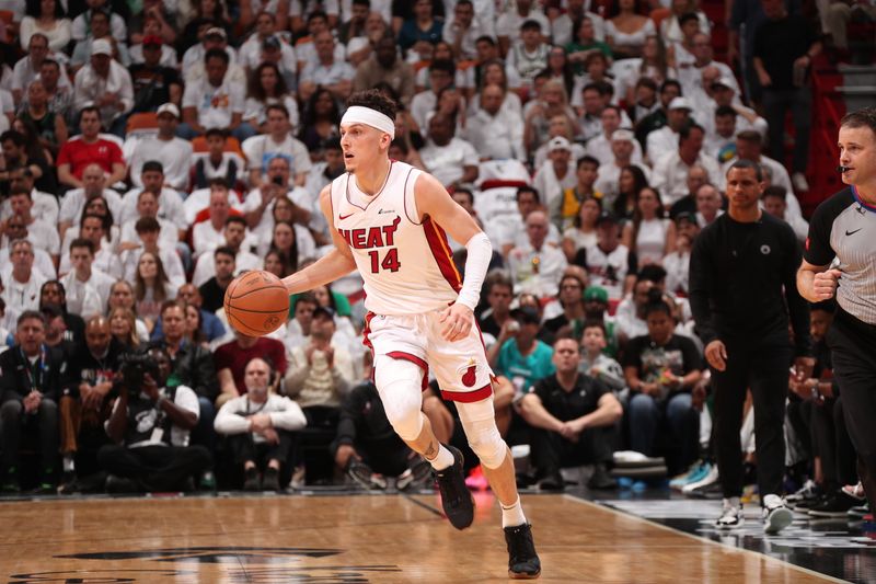 MIAMI, FL - APRIL 27: Tyler Herro #14 of the Miami Heat dribbles the ball during the game against the Boston Celtics during Round 1 Game 3 of the 2024 NBA Playoffs on April 27, 2024 at Kaseya Center in Miami, Florida. NOTE TO USER: User expressly acknowledges and agrees that, by downloading and or using this Photograph, user is consenting to the terms and conditions of the Getty Images License Agreement. Mandatory Copyright Notice: Copyright 2024 NBAE (Photo by Issac Baldizon/NBAE via Getty Images)