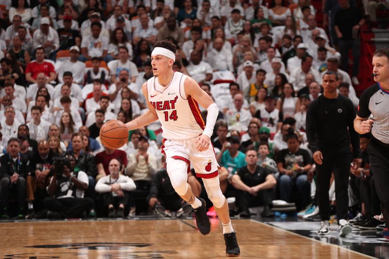 MIAMI, FL - APRIL 27: Tyler Herro #14 of the Miami Heat dribbles the ball during the game against the Boston Celtics during Round 1 Game 3 of the 2024 NBA Playoffs on April 27, 2024 at Kaseya Center in Miami, Florida. NOTE TO USER: User expressly acknowledges and agrees that, by downloading and or using this Photograph, user is consenting to the terms and conditions of the Getty Images License Agreement. Mandatory Copyright Notice: Copyright 2024 NBAE (Photo by Issac Baldizon/NBAE via Getty Images)