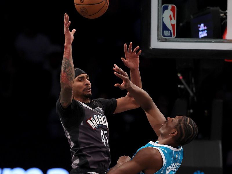 NEW YORK, NEW YORK - FEBRUARY 10: Keon Johnson #45 of the Brooklyn Nets passes as Moussa Diabate #14 of the Charlotte Hornets defends at Barclays Center on February 10, 2025 in the Brooklyn borough of New York City. NOTE TO USER: User expressly acknowledges and agrees that, by downloading and or using this photograph, User is consenting to the terms and conditions of the Getty Images License Agreement. (Photo by Elsa/Getty Images)