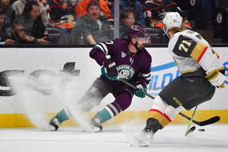 Dec 27, 2023; Anaheim, California, USA; Anaheim Ducks left wing Alex Killorn (17) moves the puck against Vegas Golden Knights defenseman Ben Hutton (17) during the first period at Honda Center. Mandatory Credit: Gary A. Vasquez-USA TODAY Sports