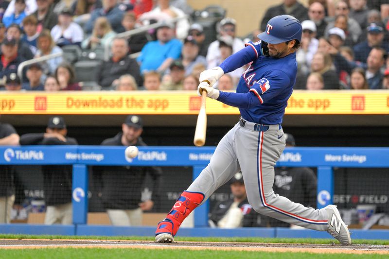 May 26, 2024; Minneapolis, Minnesota, USA; Texas Rangers infielder Josh Smith (8) hits a single against the Minnesota Twins during the first inning at Target Field. Mandatory Credit: Nick Wosika-USA TODAY Sports