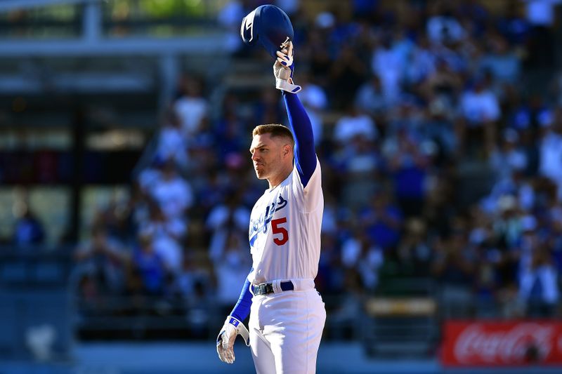 Jun 25, 2023; Los Angeles, California, USA; Los Angeles Dodgers first baseman Freddie Freeman (5) reacts after recording his 2,000th career hit on an RBI double against the Houston Astros during the eighth inning at Dodger Stadium. Mandatory Credit: Gary A. Vasquez-USA TODAY Sports