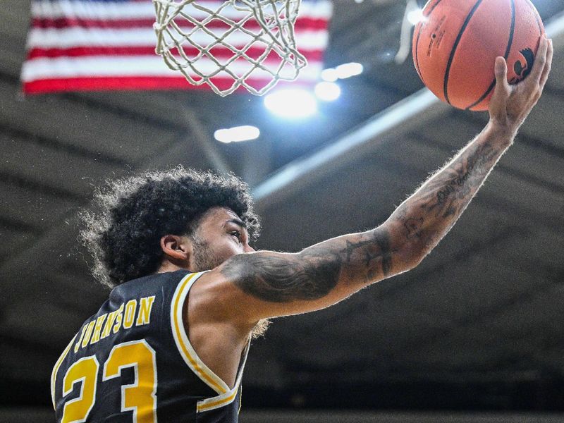 Dec 20, 2023; Iowa City, Iowa, USA; UMBC Retrievers guard Bryce Johnson (23) goes to the basket against the Iowa Hawkeyes during the first half at Carver-Hawkeye Arena. Mandatory Credit: Jeffrey Becker-USA TODAY Sports