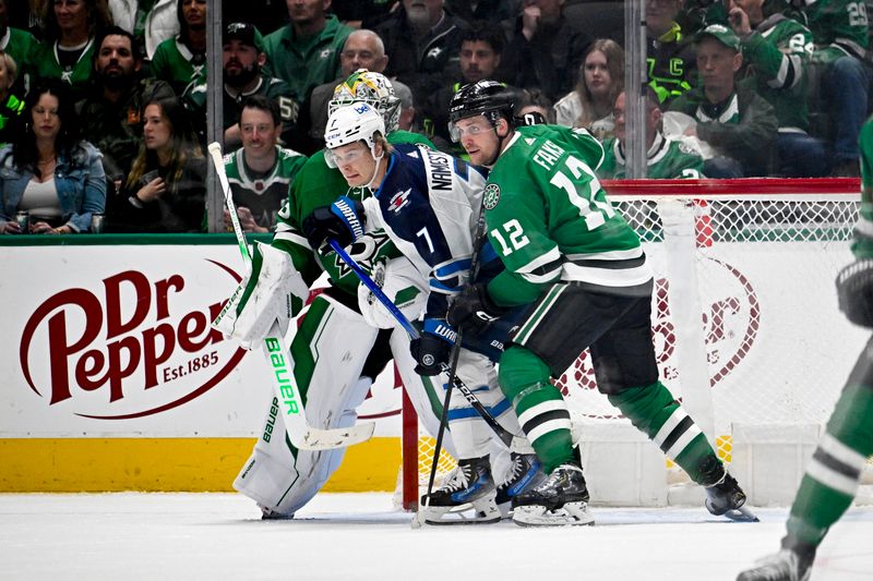 Feb 29, 2024; Dallas, Texas, USA; Winnipeg Jets center Vladislav Namestnikov (7) and Dallas Stars center Radek Faksa (12) look for the puck in front of goaltender Jake Oettinger (29) during the second period at the American Airlines Center. Mandatory Credit: Jerome Miron-USA TODAY Sports