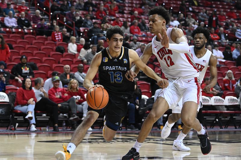 Feb 14, 2023; Las Vegas, Nevada, USA; San Jose State Spartans guard Alvaro Cardenas (13) drives to the net past UNLV Runnin' Rebels center David Muoka (12) in the second half at Thomas & Mack Center. Mandatory Credit: Candice Ward-USA TODAY Sports