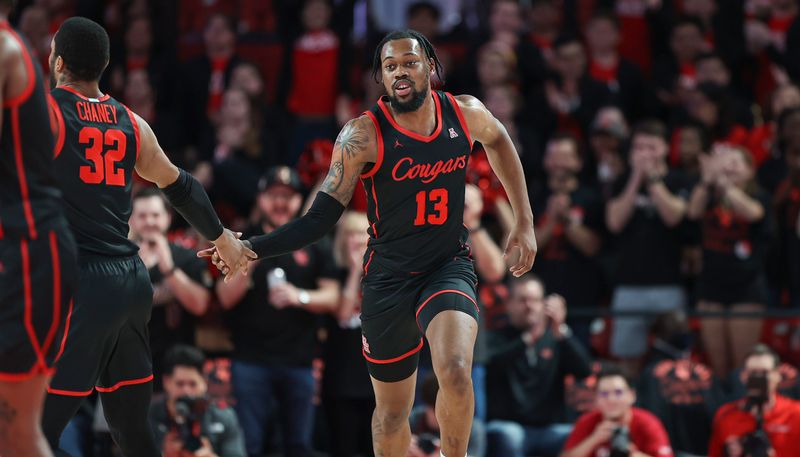 Feb 22, 2023; Houston, Texas, USA; Houston Cougars forward J'Wan Roberts (13) reacts after scoring a basket during the first half against the Tulane Green Wave at Fertitta Center. Mandatory Credit: Troy Taormina-USA TODAY Sports