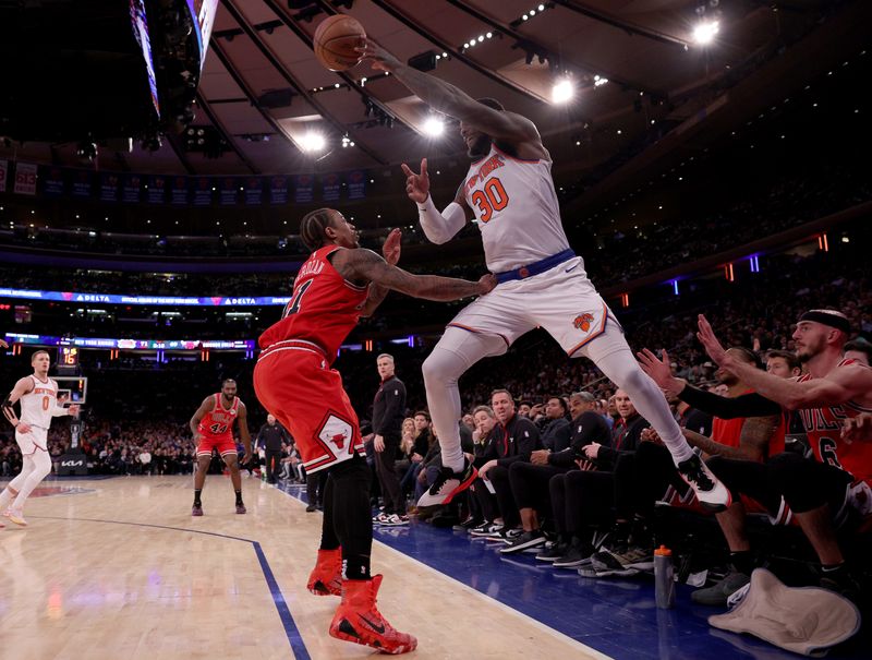 NEW YORK, NEW YORK - JANUARY 03: Julius Randle #30 of the New York Knicks keeps the ball in bounds as he gets the turnover while DeMar DeRozan #11 of the Chicago Bulls defends during the second half at Madison Square Garden on January 03, 2024 in New York City. The New York Knicks defeated the Chicago Bulls 116-100. NOTE TO USER: User expressly acknowledges and agrees that, by downloading and or using this photograph, User is consenting to the terms and conditions of the Getty Images License Agreement. (Photo by Elsa/Getty Images)