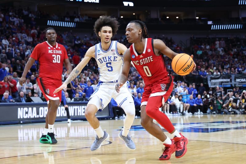 Mar 31, 2024; Dallas, TX, USA; North Carolina State Wolfpack guard DJ Horne (0) controls the ball against Duke Blue Devils guard Tyrese Proctor (5) in the second half in the finals of the South Regional of the 2024 NCAA Tournament at American Airline Center. Mandatory Credit: Kevin Jairaj-USA TODAY Sports