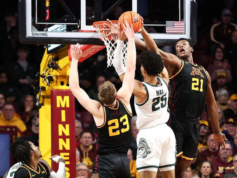 Feb 6, 2024; Minneapolis, Minnesota, USA; Minnesota Golden Gophers forward Pharrel Payne (21) fouls as Michigan State Spartans forward Malik Hall (25) shoots during the first half at Williams Arena. Mandatory Credit: Matt Krohn-USA TODAY Sports