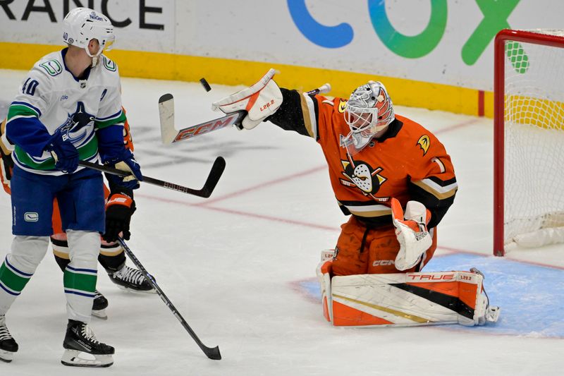 Nov 5, 2024; Anaheim, California, USA; Anaheim Ducks goaltender Lukas Dostal (1) makes a save off a shot by Vancouver Canucks center Elias Pettersson (40) in the second period at Honda Center. Mandatory Credit: Jayne Kamin-Oncea-Imagn Images